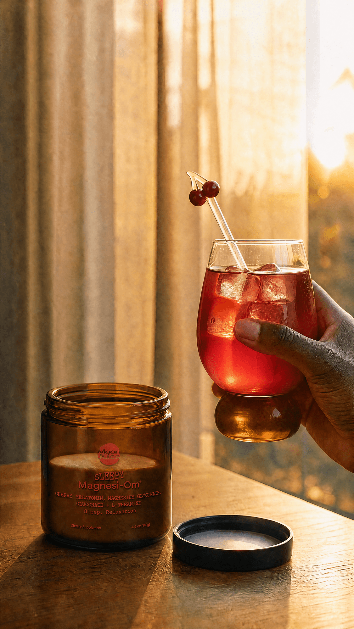 Amber jar of cherry sleep supplement powder beside an iced drink