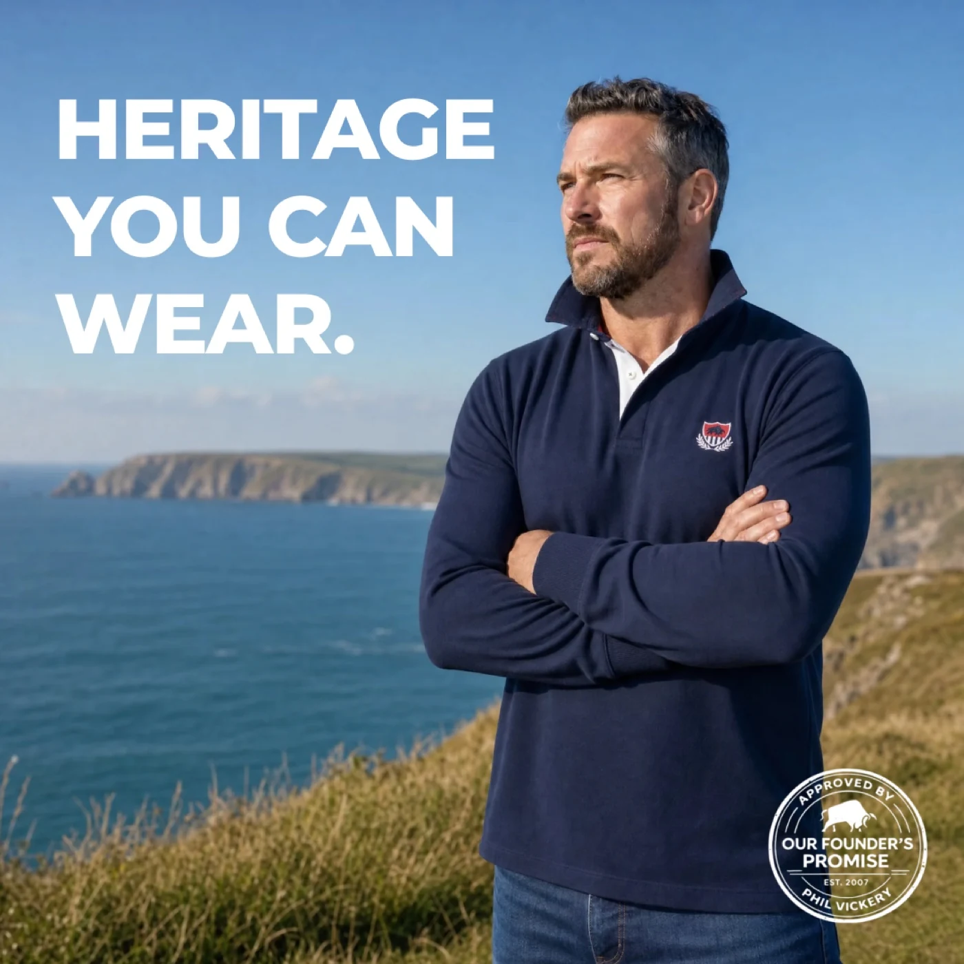 A model wearing a navy Raging Bull polo shirt by the sea